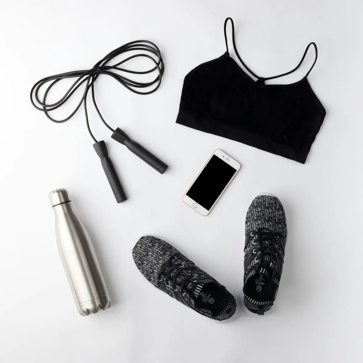 Workout clothes, trainers and a bottle laid out